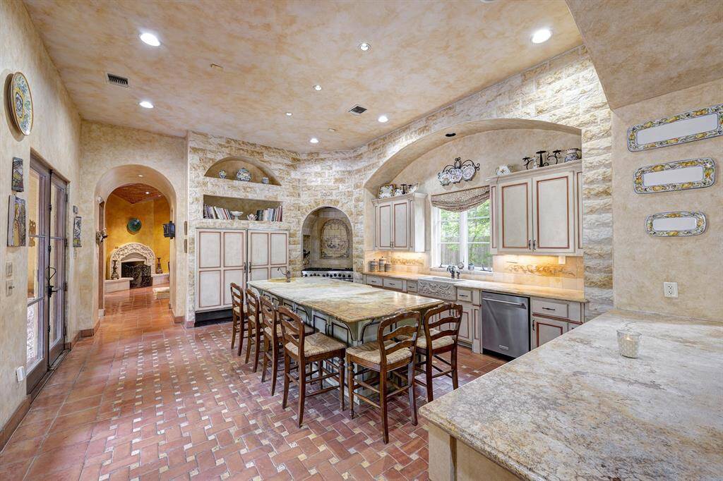 Chef's kitchen with large island overlooks the courtyard