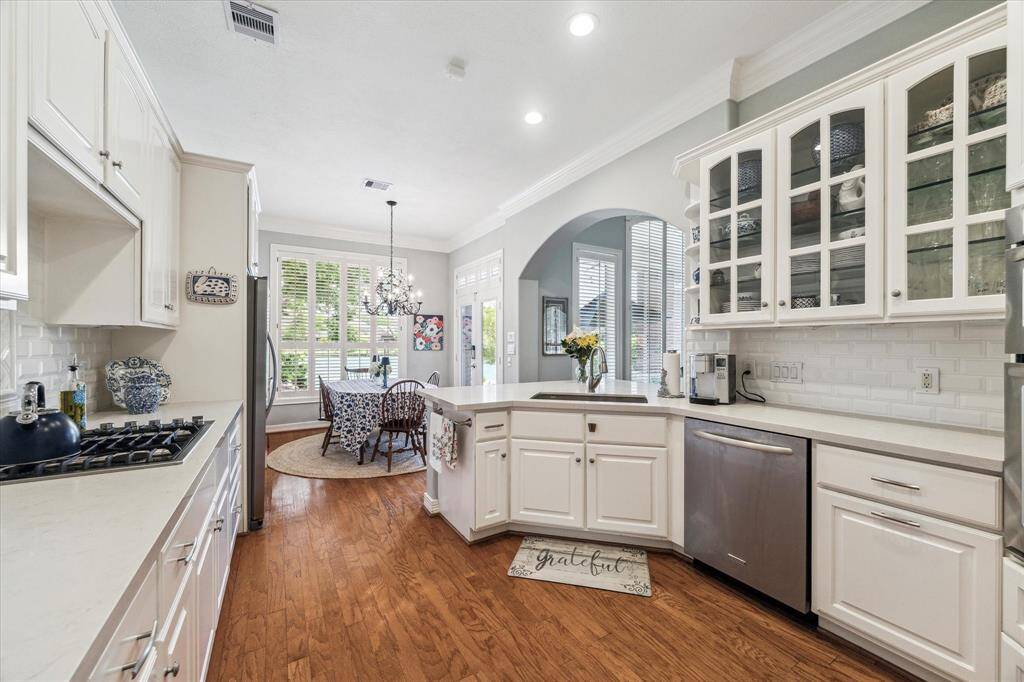This well appointed kitchen has glass front cabinets, gas cooktop, microwave and oven and great storage and counter space.