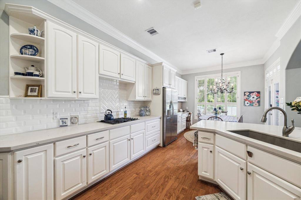Pretty detailing in the cabinetry and backsplash and finishes make this kitchen not only practical but a delightful place to be!