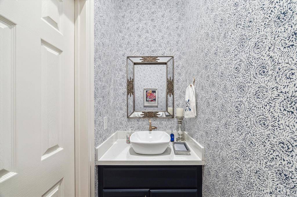 Lovely downstairs powder room conveniently located between the entry hall and door to garage.