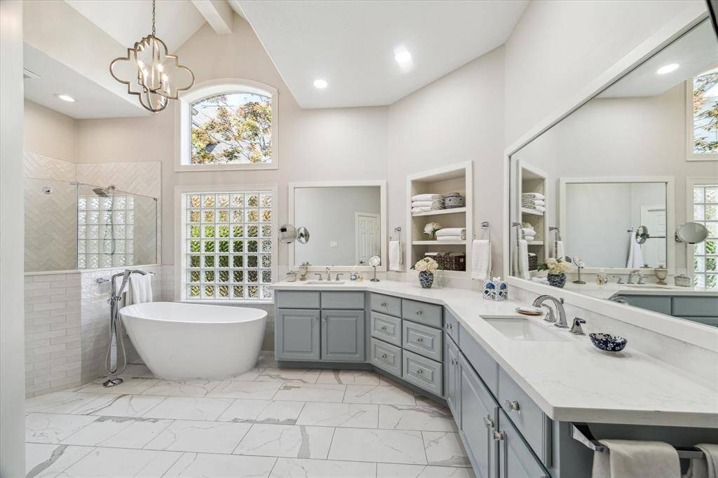Luxurious primary bath has double sinks, lots of counter space, large oval tub, separate shower and huge walk-in closet.  Like having your own private spa.
