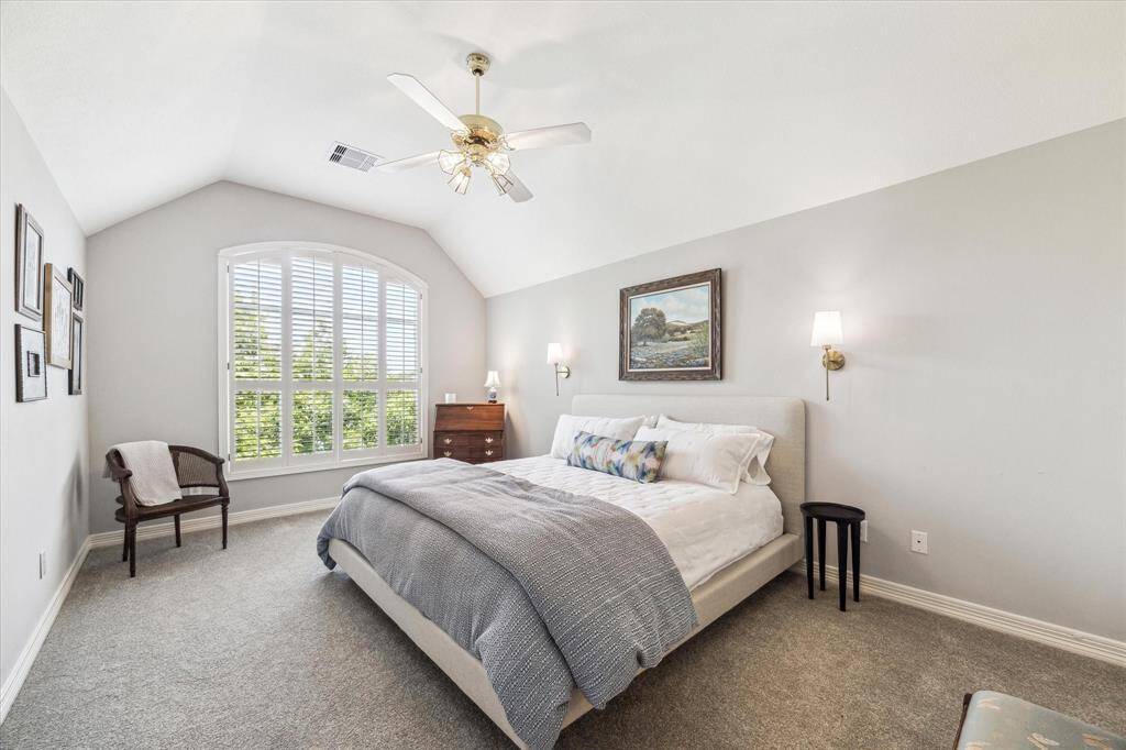 This wonderful upstairs bedroom has a ceiling fan, high ceilings and THE VIEW!. There is also a huge attic space for storage.