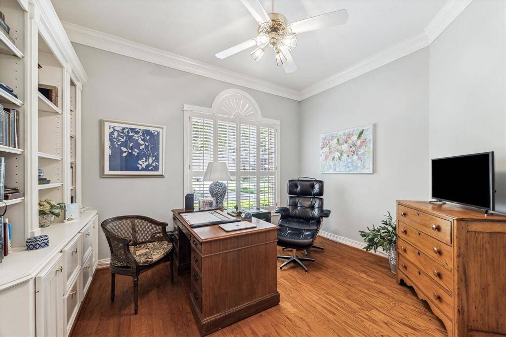 Downstairs home office/study/library has great built-ins, ceiling fan, and wonderful windows overlooking front lawn.