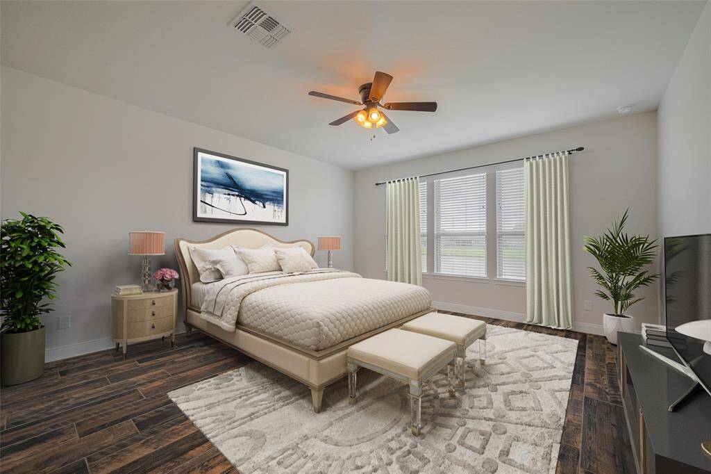 Primary bedroom is in the back of the house and offers serene views of the lake. Virtually staged.