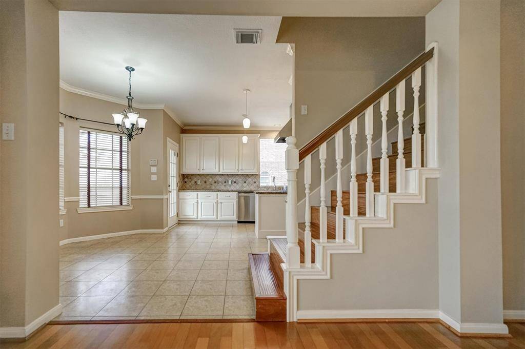 This family room connecting to kitchen through breakfast area. Another staircase leading to upstairs.