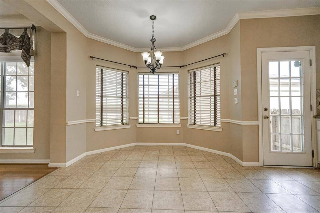 The bright and inviting breakfast area, perfectly positioned to capture the morning sun through a lovely set of bay windows
