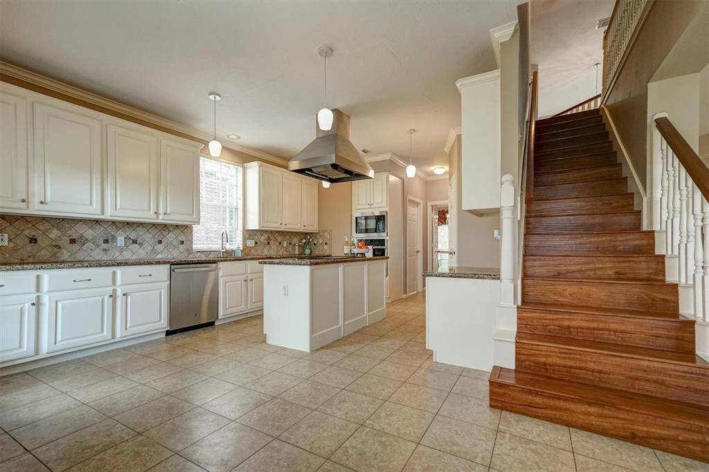 This beautifully designed kitchen is featuring sleek granite countertops and an abundance of cabinetry for all your storage needs.