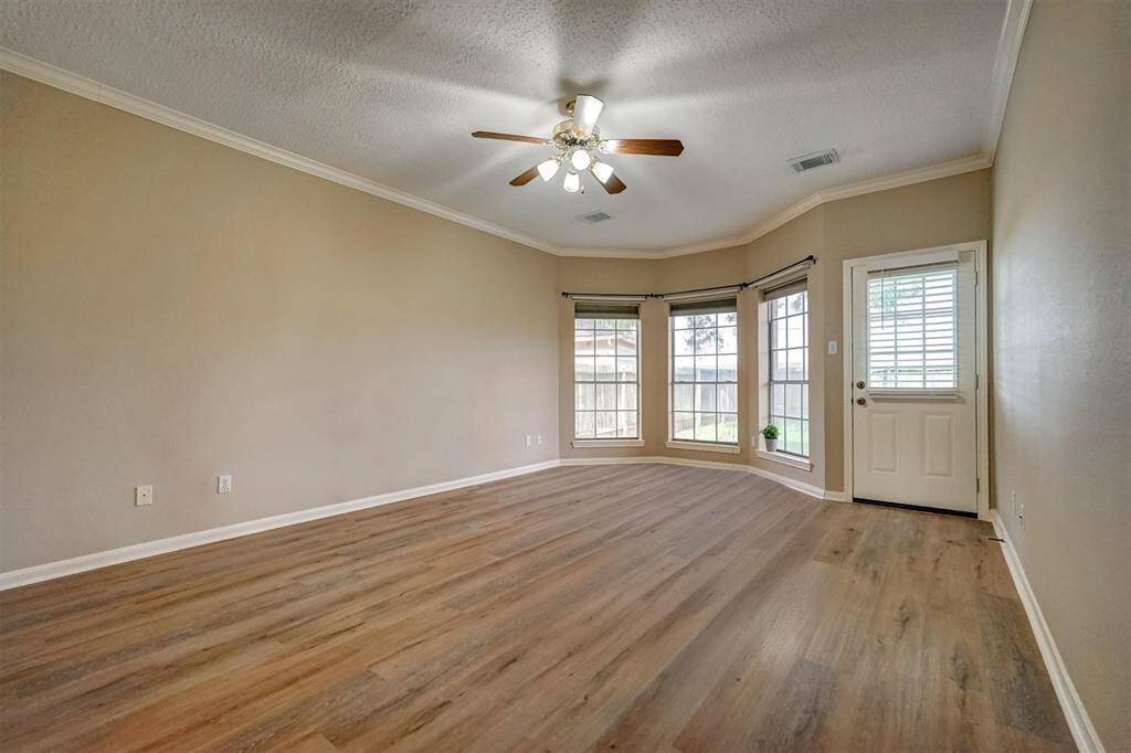 Spacious master bedroom with bay window and new luxury vinyl planks