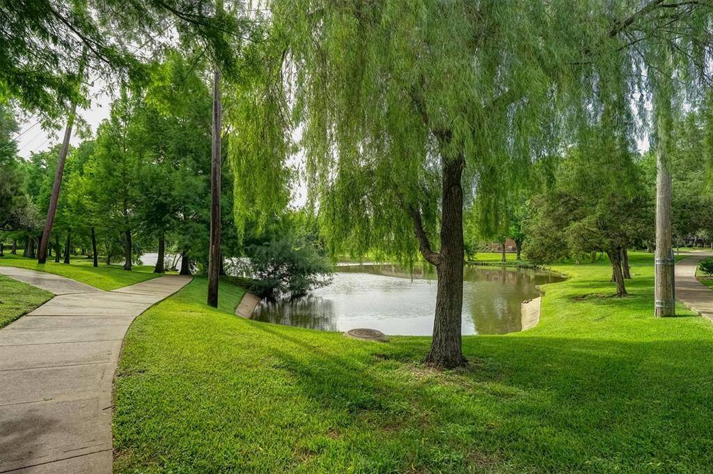 The beautiful crescent lake trail around a serene lake within the subdivision