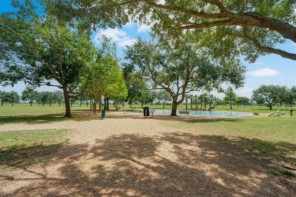 Well maintained dog park designed for both pets and their owners, featuring a peaceful pond plenty, open space and outdoor chairs for owners to relax and socialize.