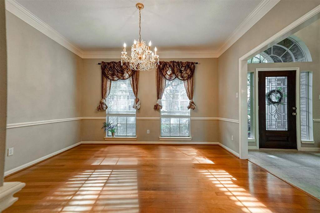 A stylish light fixture adds a refined focal point, making this space perfect for hosting dinner parties or enjoying intimate family meals in a beautifully appointed setting.