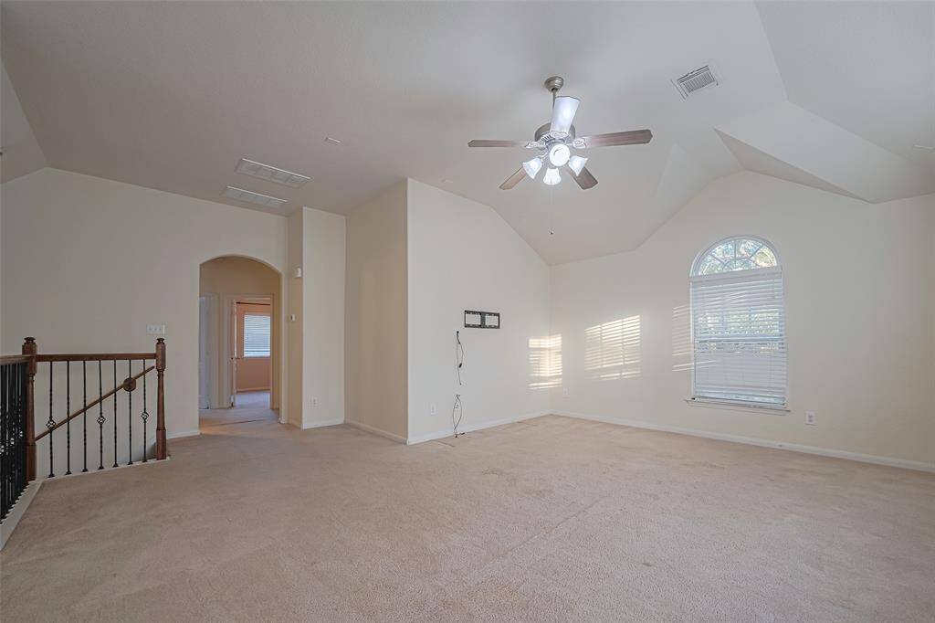 Perfect for entertaining is this amazing game room! Right upstairs this space would be a fabulous teen hangout, media room, or adult game room complete with pool table and big screen TVs. Featuring plush carpet, high ceilings, dark stained ceiling fan, custom paint and large windows with privacy blinds.