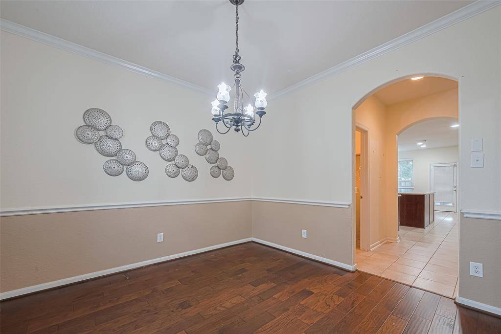 Make memories gathered around the table with your family and friends! This dining room features high ceilings, crown molding, chair rail, large window, wood flooring and a beautiful chandelier.