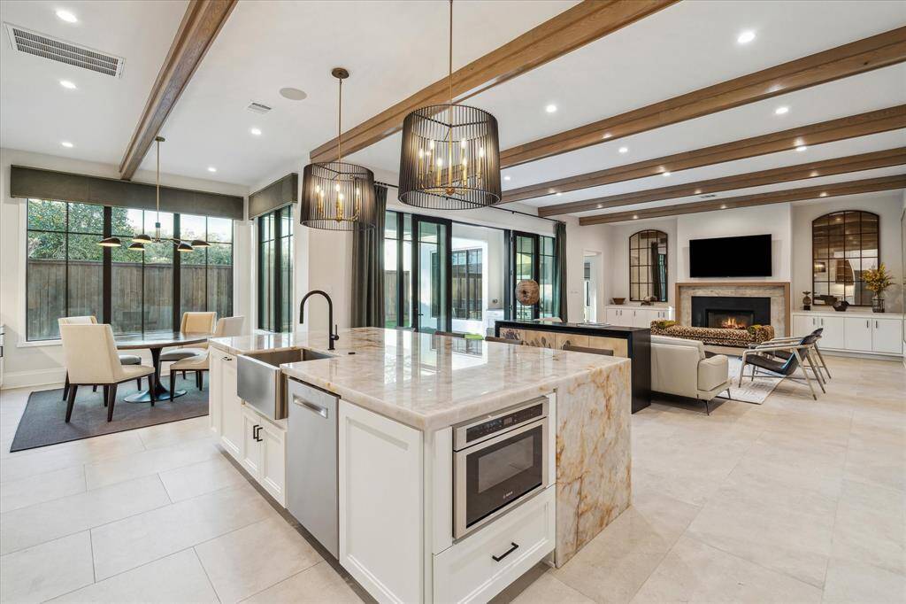 The kitchen’s open-concept design connects effortlessly to the breakfast room and family room. This layout ensures a seamless flow, perfect for both entertaining and everyday living.