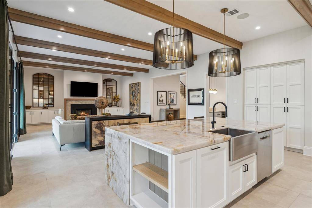 The kitchen’s connectivity to the family room and wet bar enhances both convenience and entertaining potential. Its refined finishes and functional layout make it a true centerpiece of the home.