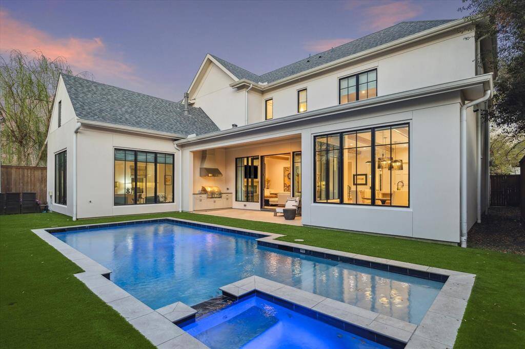 The backyard oasis offers a heated pool and spa, artificial turfed lawn, and a covered patio with a summer kitchen. Thoughtfully designed for effortless outdoor entertaining, this serene space is perfect for gatherings year-round.
