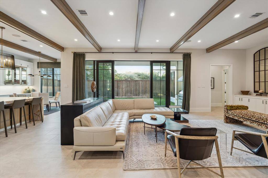 French doors open from the family room to the pool area, creating an effortless indoor-outdoor flow. This thoughtful design element enhances the home's entertaining appeal while providing serene backyard views.