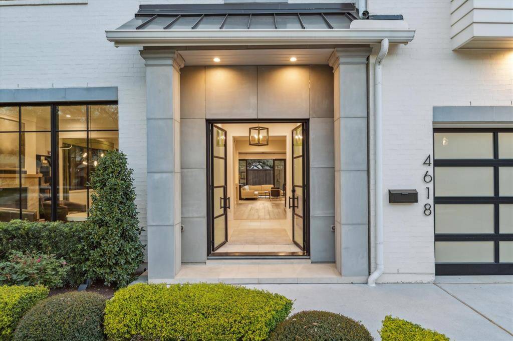 The custom French front doors, adorned with intricate glass paneling, create a memorable entry statement. These beautifully designed doors invite natural light while offering a glimpse of the refined interiors beyond. Their classic design seamlessly complements the home's timeless aesthetic.