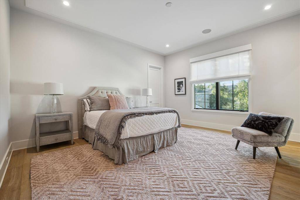 Guest bedroom #3 offers northern exposure views, custom window treatments, and designer ceiling accents. Its warm, neutral palette enhances the room's charm.