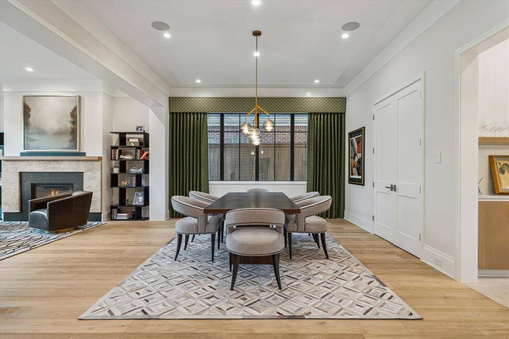 The sophisticated formal dining room offers a spacious walk-in storage closet, ideal for future wine storage or fine china display. This room’s refined finishes, custom window treatments, and seamless flow make it an ideal setting for memorable gatherings.
