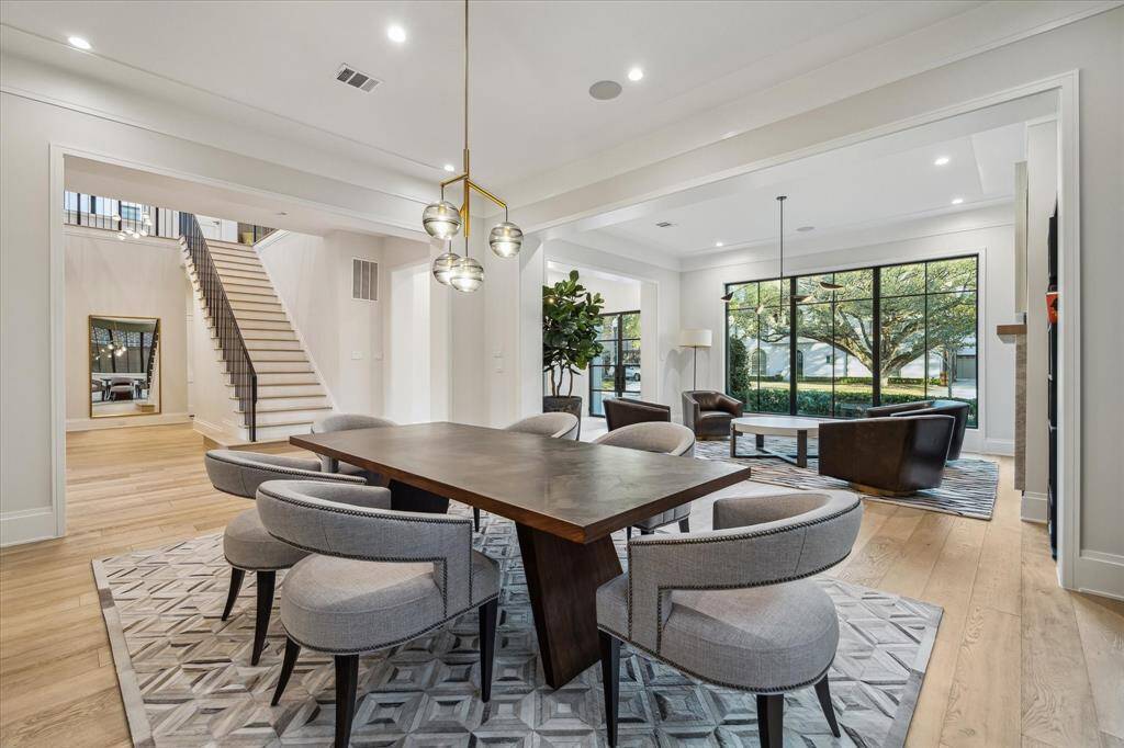 The formal dining room connects effortlessly to the foyer, formal living room, and main staircase. This open yet defined layout offers both elegance and convenience, ensuring seamless entertaining.