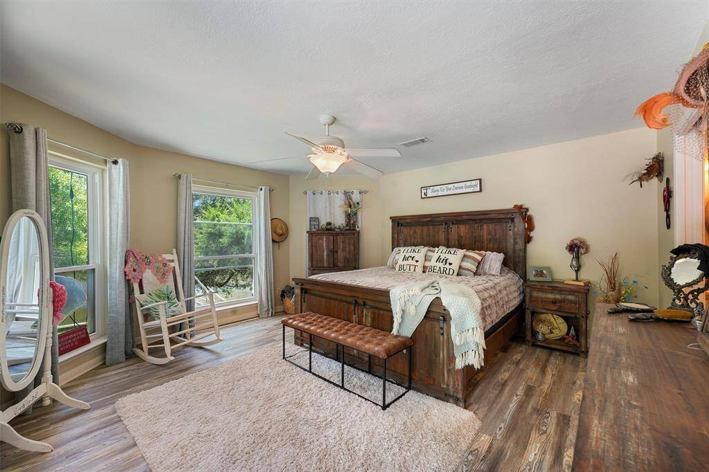 Large primary bedroom that has views of the river and the pool