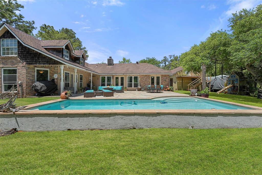 Sparkling pool at the back of the home with a river view