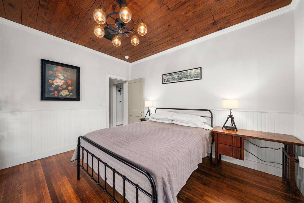 Gleeming hardwood flooring in primary bedroom.