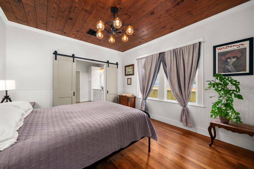Barn doors access the primary bathroom.