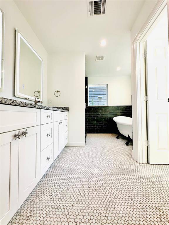 Primary double-sink bathroom with separate water closet