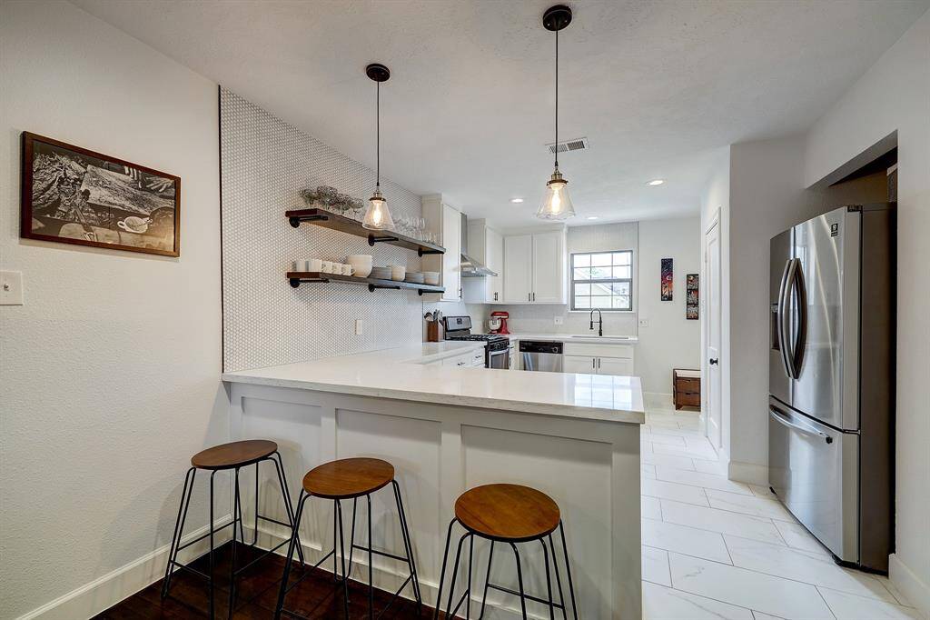The kitchen was totally remodeled in 2021 with all new cabinets, quartz counter tops, and white penny tile back splash.