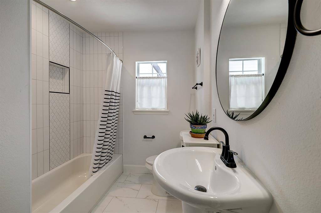 The secondary bathroom is conveniently located between the living space and the secondary bedrooms.