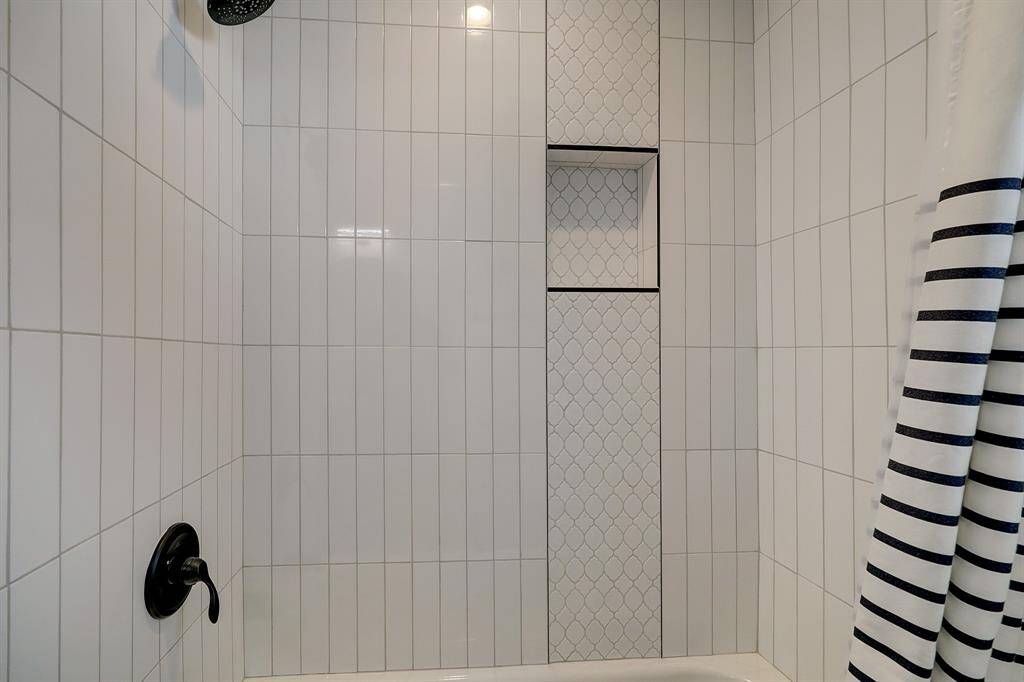 The tile detail in the secondary bathroom showcases the quality of craftsmanship and attention to detail of the home.