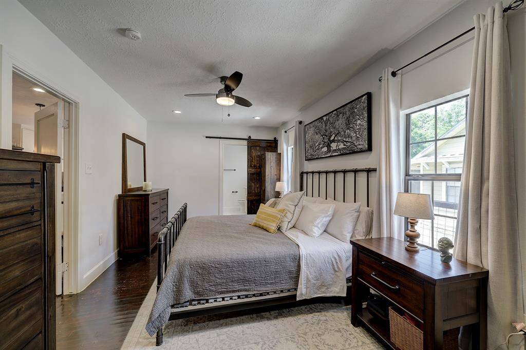 The primary suite is large and accommodates a king sized bed and several pieces of furniture.