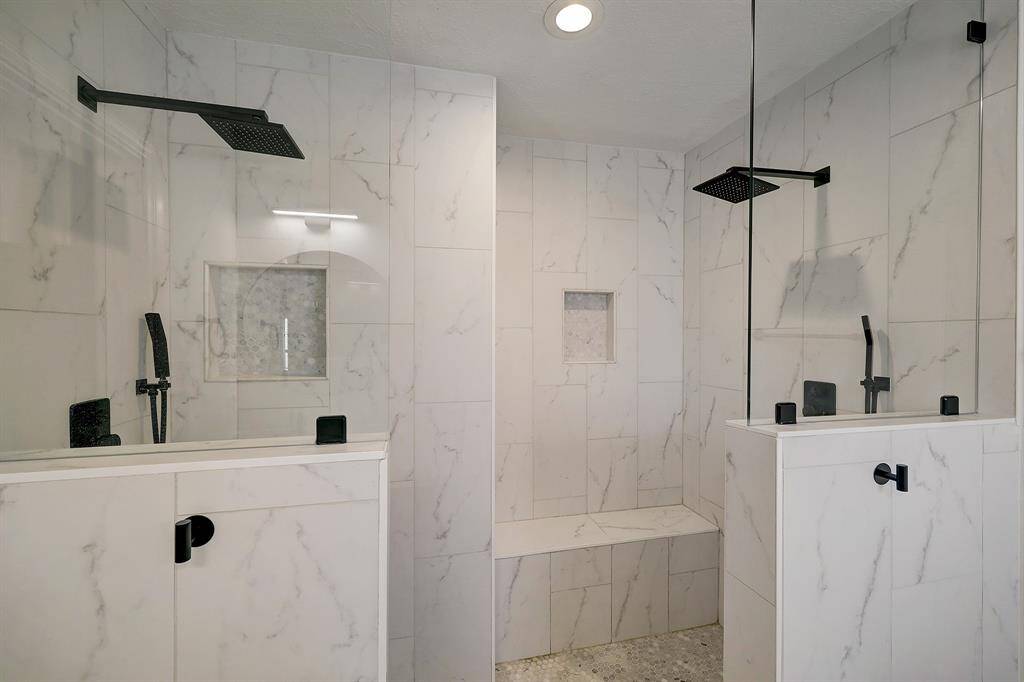 Rain shower heads and shower wands make this shower super functional as well as beautiful.