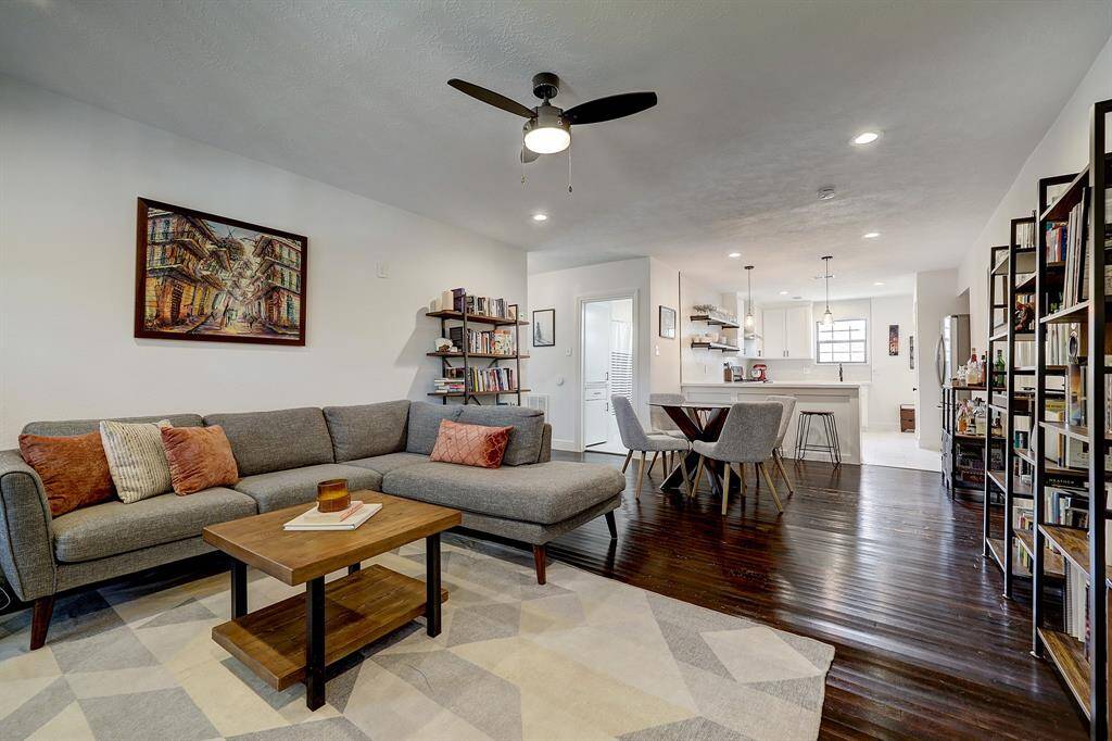 The living room is expansive and has recessed lighting and a ceiling fan.