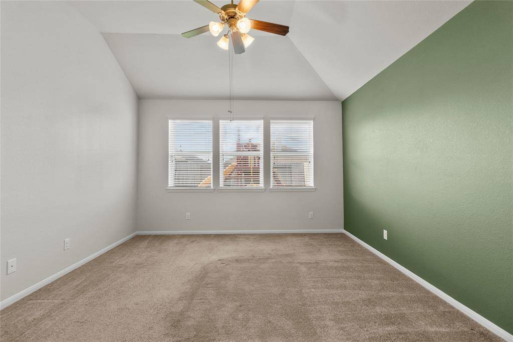 Serene and airy primary bedroom featuring tall ceilings and generous windows for a light-filled retreat.