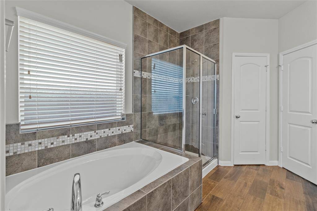 Well-designed ensuite with stunning floors, garden tub, separate shower, and a closet that exceeds expectations.