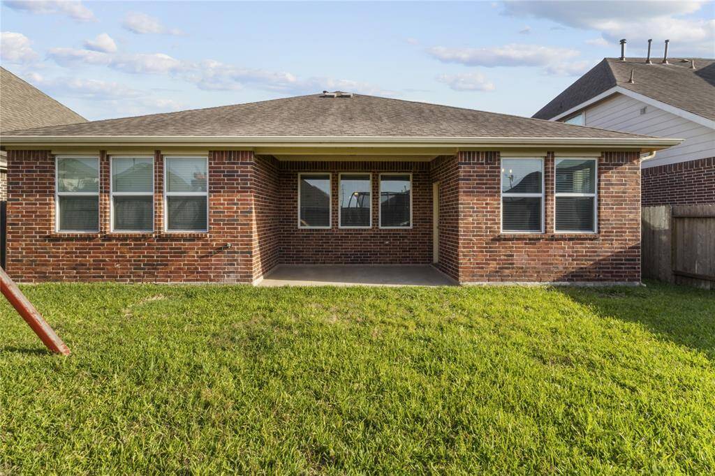 Generous back porch perfect for entertaining, with the bonus of full brick construction all the way around.