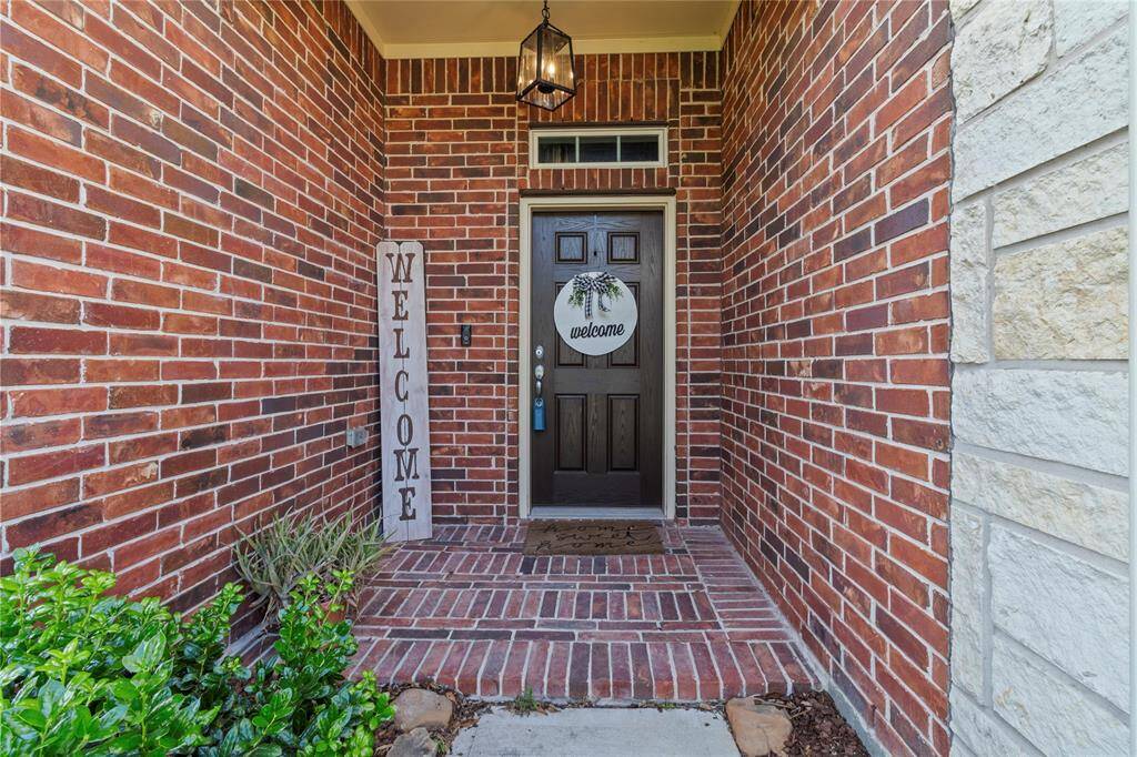 Classic brickwork and an elegant transom window create a welcoming first impression.