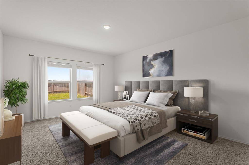 This primary bedroom greets you with plush carpet, high ceilings, and large windows with blinds allowing in natural light to brighten up this spacious primary bedroom. *This photo has been virtually staged