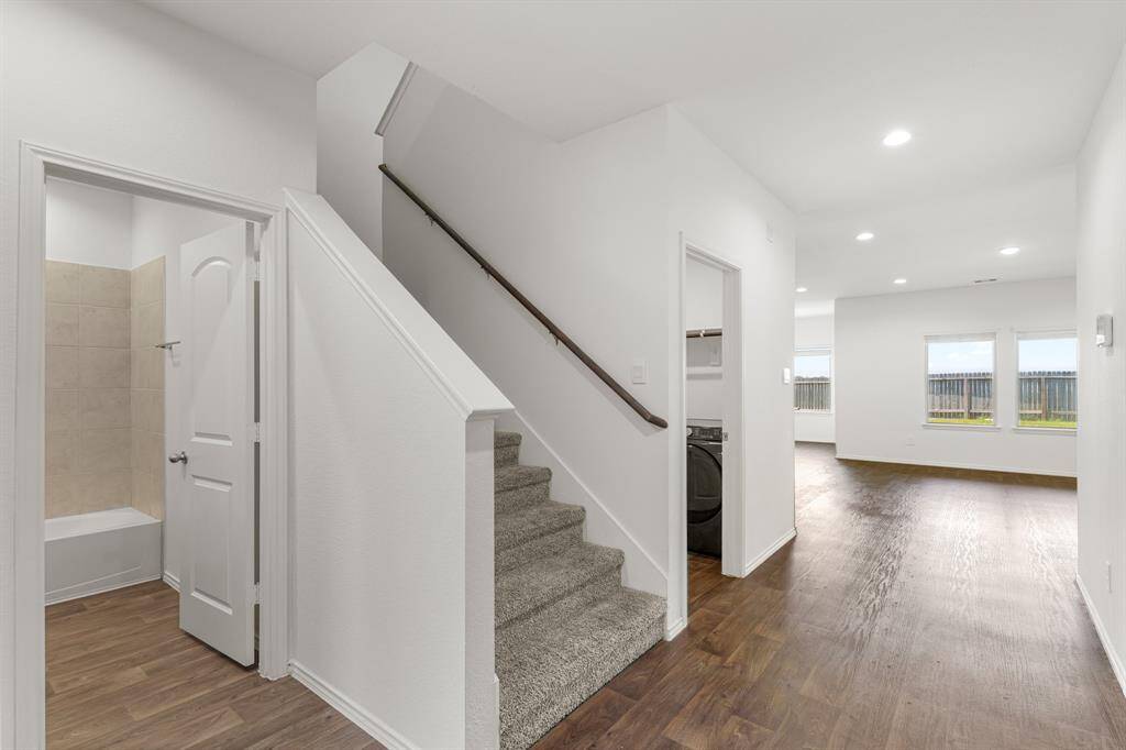 Upon entering you find a welcoming corridor showcasing beautiful floors, high ceilings, and the staircase to the second floor!