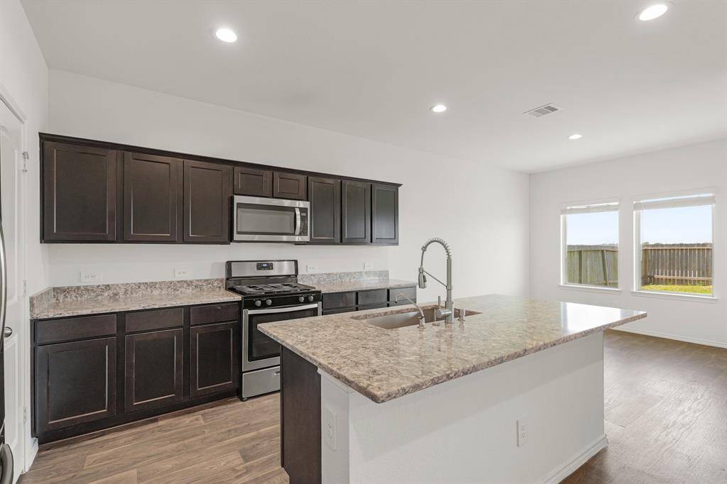 This kitchen conveniently connects to the breakfast area and living room for easy entertaining!