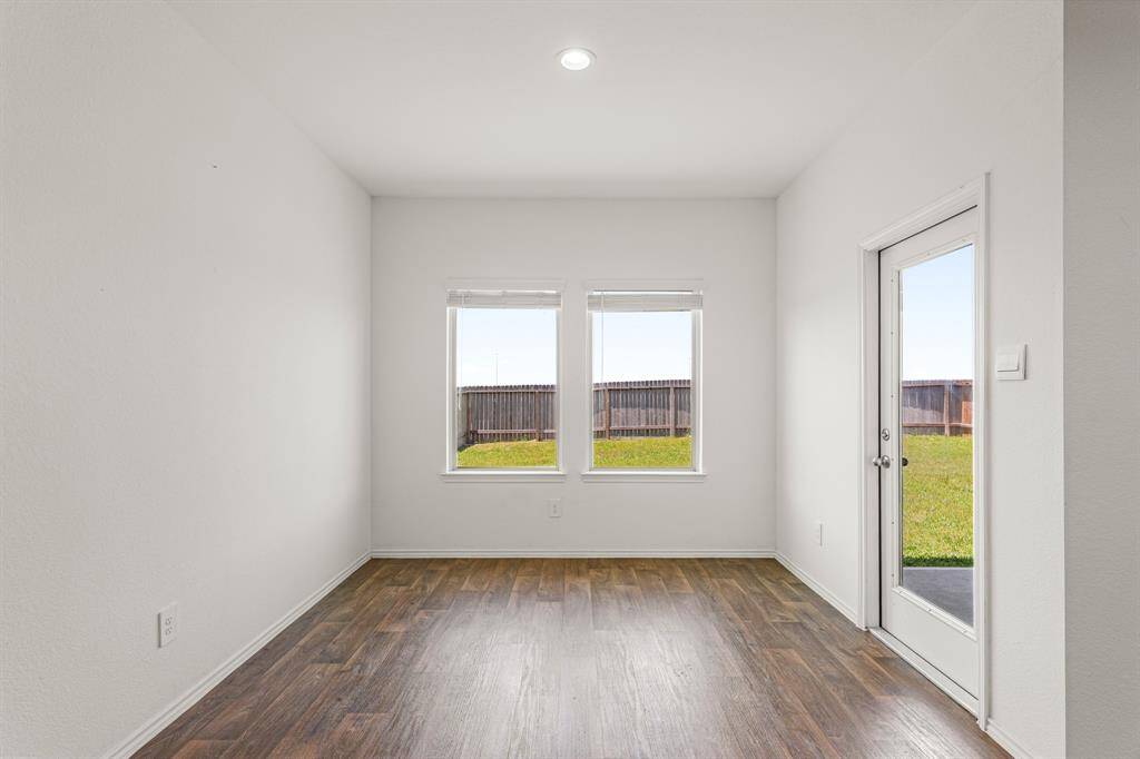 This breakfast area is perfect for starting the day out on the right foot! This space showcases high ceilings and a large window adding to the ample natural light in the kitchen!