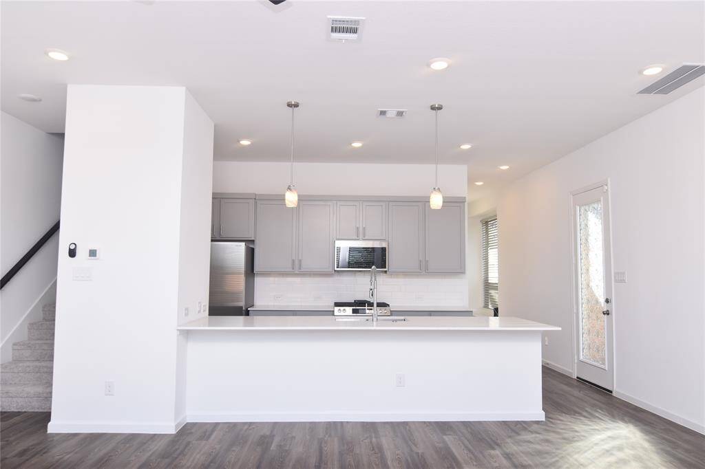 Bright ans open kitchen and family room that features an eight ft island