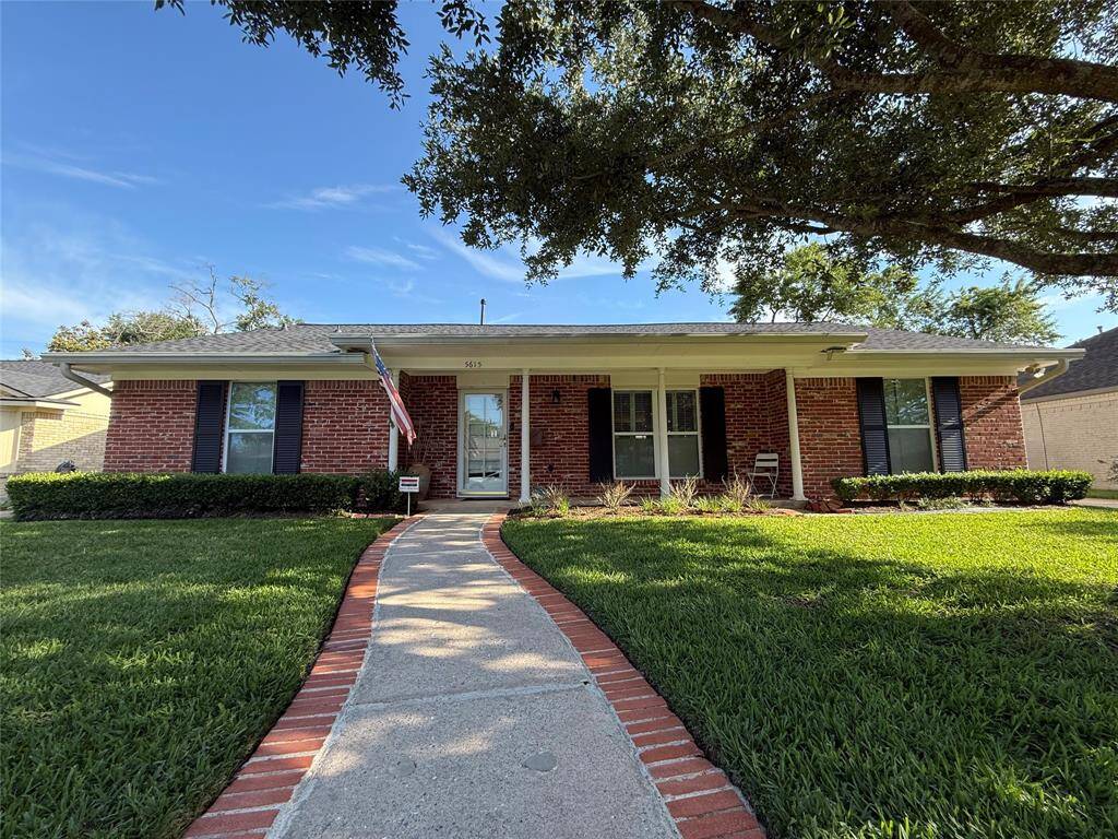 Gorgeous red brick front elevation with large, covered porch.