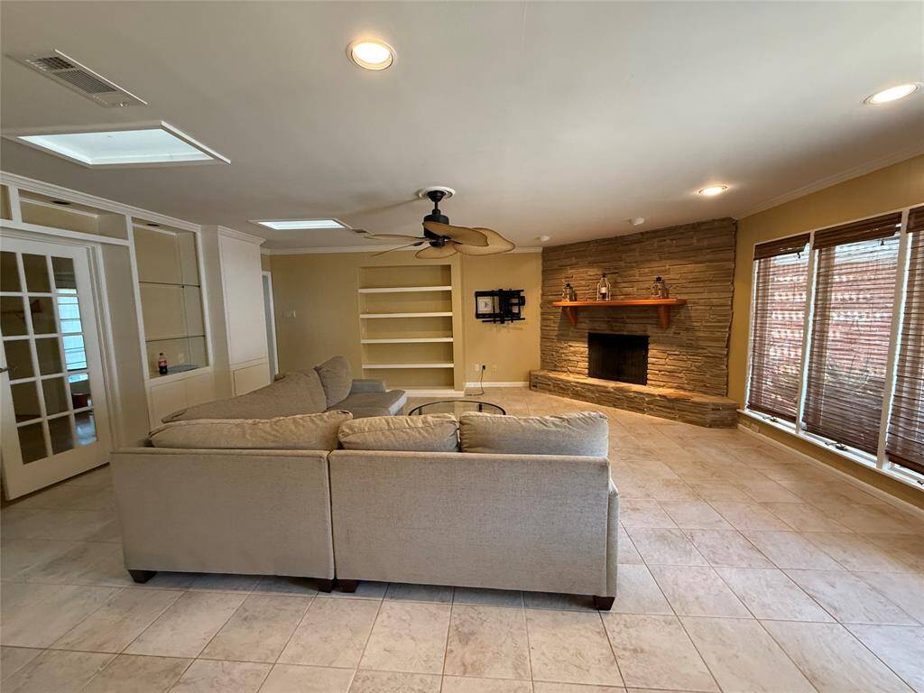 Updated Family Room with corner stone fireplace.