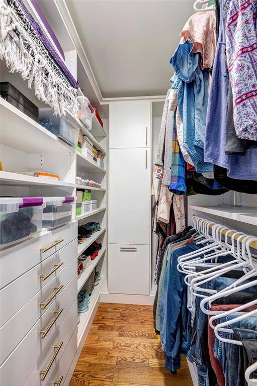 One of two primary closets with custom built-ins