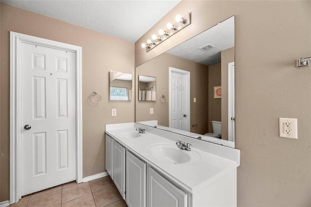 The primary bathroom is private and inviting, roomy enough to move around comfortably.