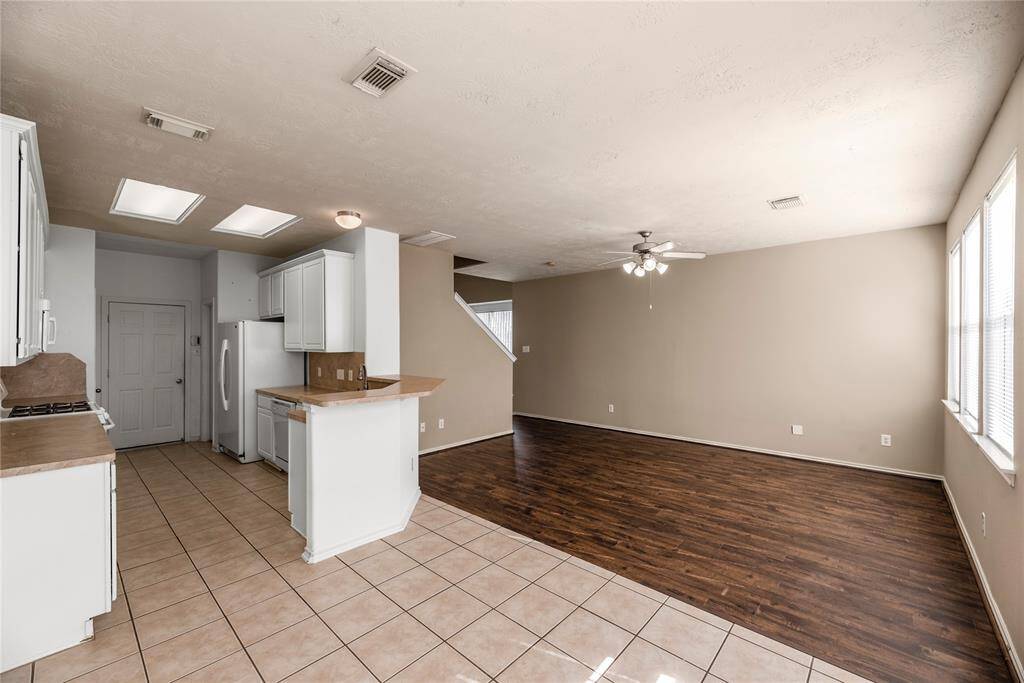 The dining area is perfectly positioned between the kitchen and living room, creating a natural flow that's ideal for both casual meals and formal gatherings.